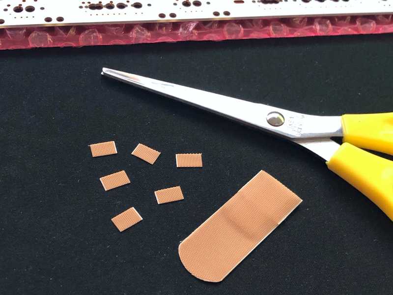 Cutting small pieces of band aid